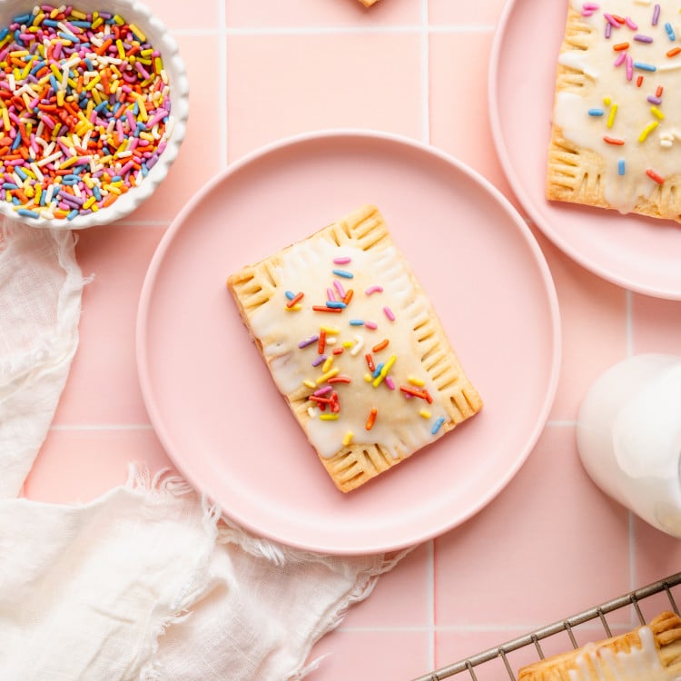 Homemade strawberry pop tart on a pink plate.