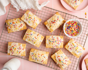 Decorated pop tarts allowing the icing and sprinkles to set on a wire rack before eating.