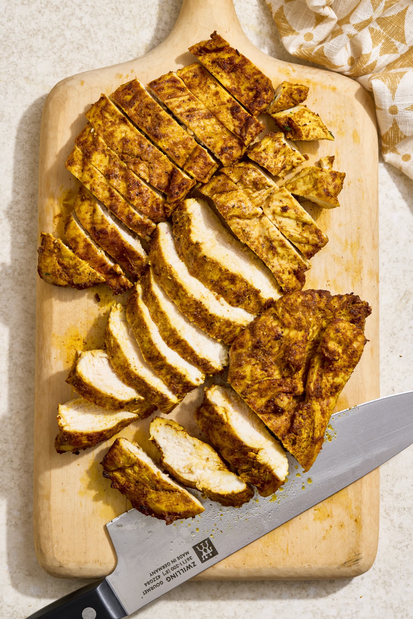Air fryer chicken shawarma sliced on a wooden cutting board after cooking and resting.