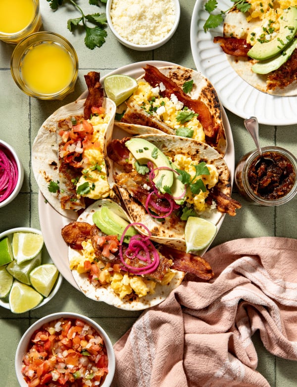 Loaded breakfast tacos assembled on large serving plate.