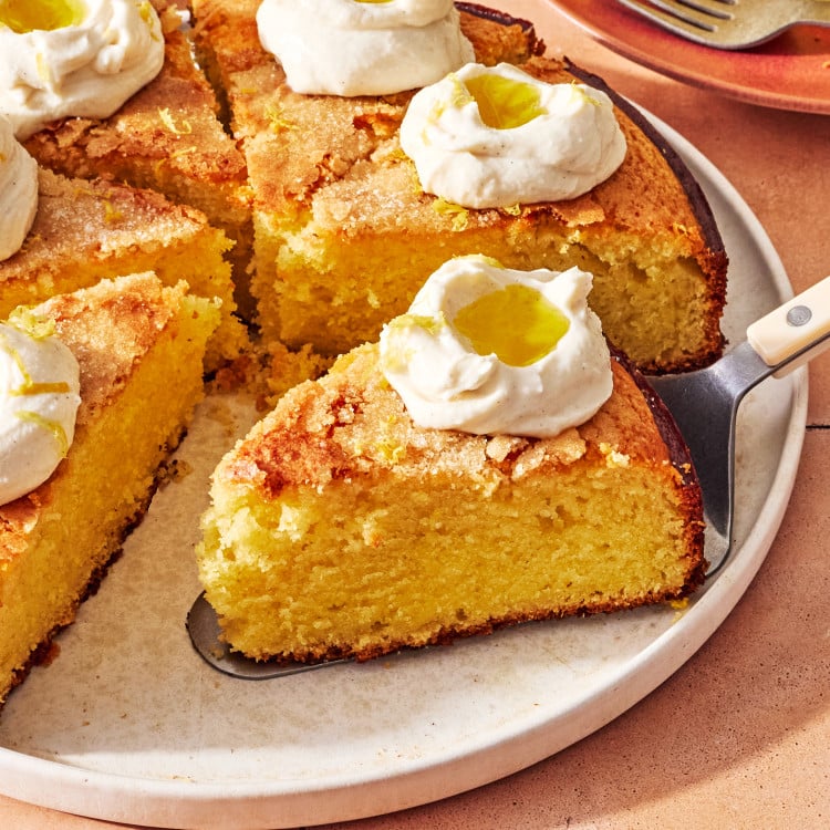 Spatula picking up a slice of lemon olive oil cake.