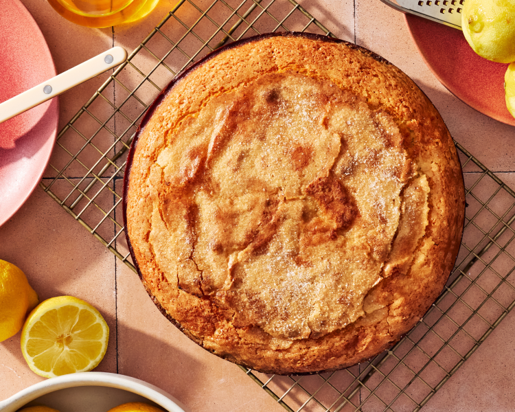 Lemon olive oil ricotta cake baked and cooling on a wire rack.