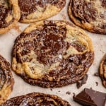Pan banging chocolate chunk cookies baked and garnished with flaky sea salt.