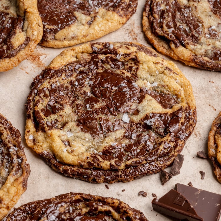 Pan banging chocolate chunk cookies baked and garnished with flaky sea salt.