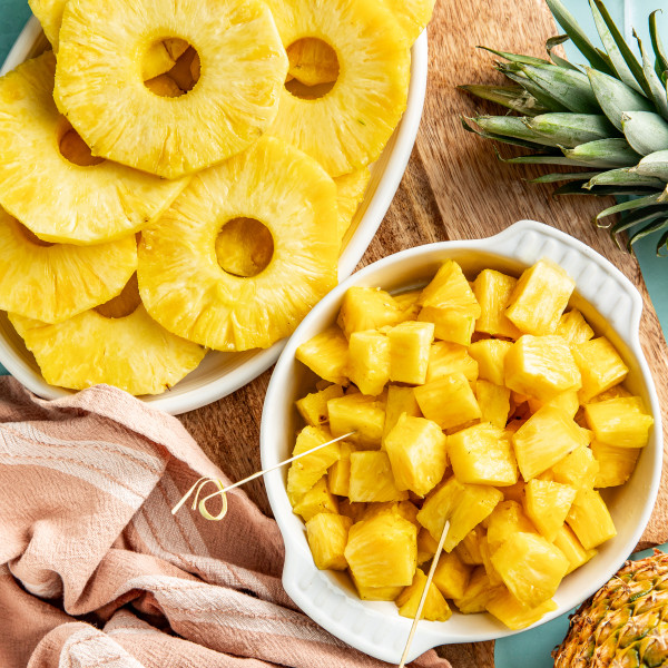 Fresh pineapple chunks and rings sliced and set beside each other.
