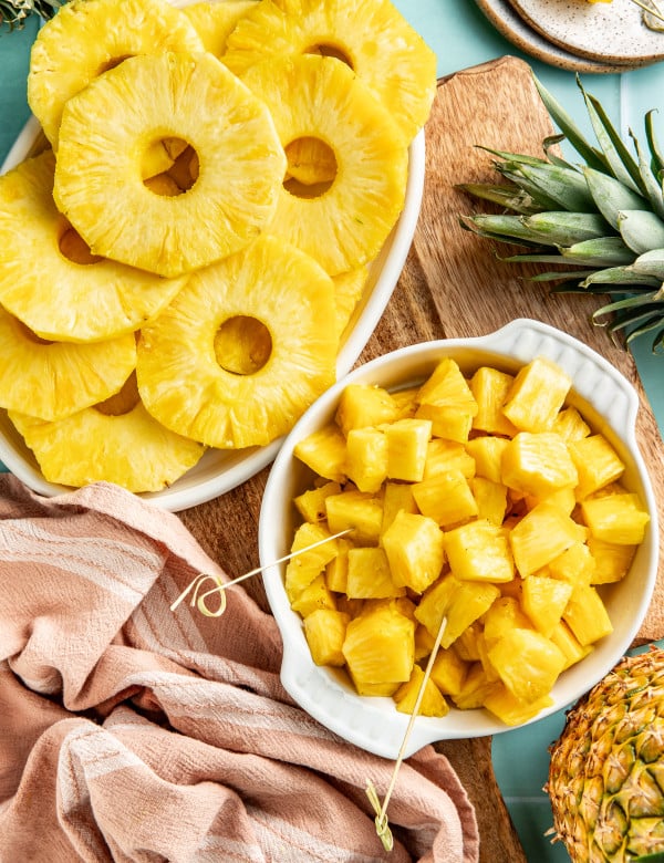 Fresh pineapple chunks and rings sliced and set beside each other.
