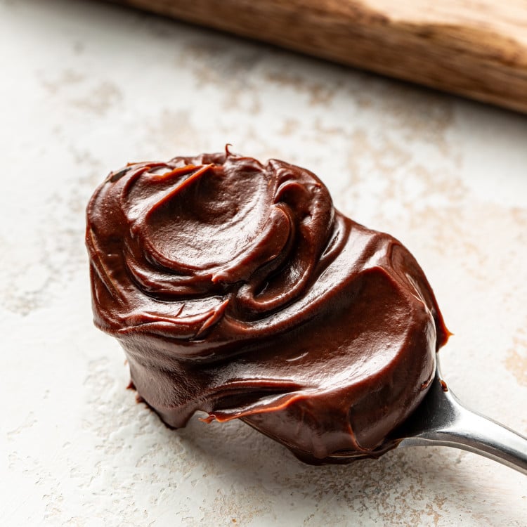 Thick chocolate ganache on a spoon.