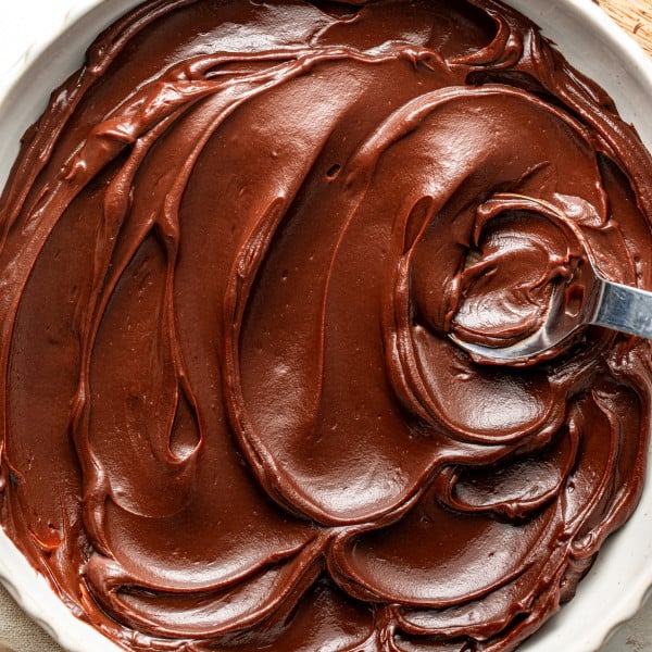 Chocolate ganache in a large serving bowl with spoon