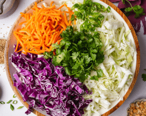Slaw ingredients combined in large serving bowl.