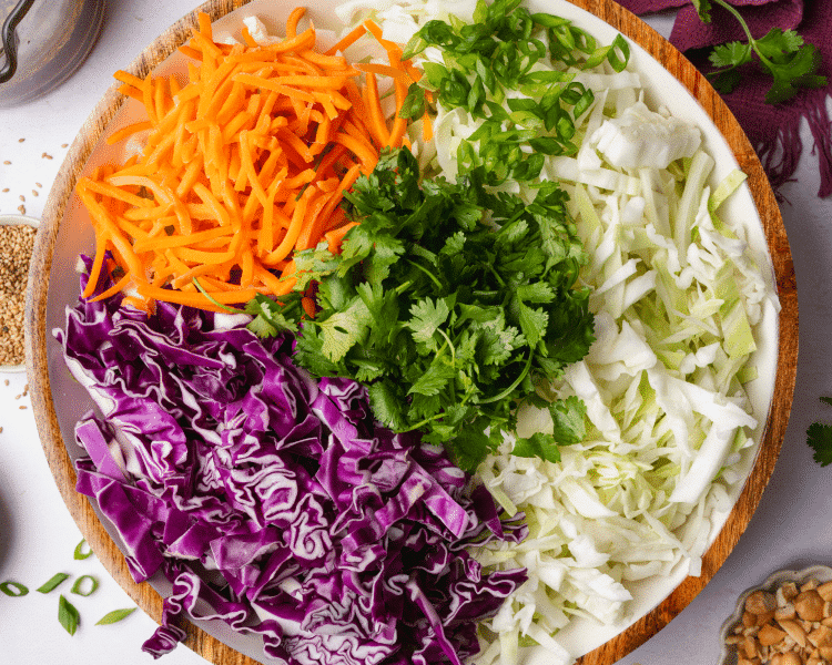 Slaw ingredients combined in large serving bowl.