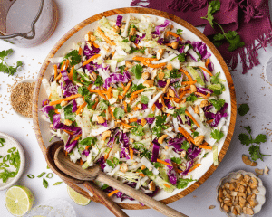 Asian slaw tossed and topped with peanuts and toasted sesame seeds.