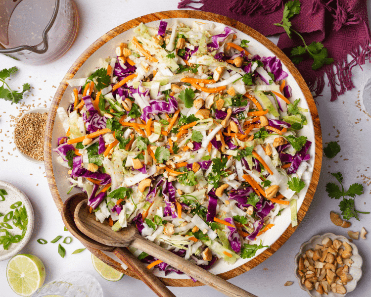 Asian slaw tossed and topped with peanuts and toasted sesame seeds.
