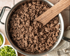 Cooking the ground beef in the skillet.