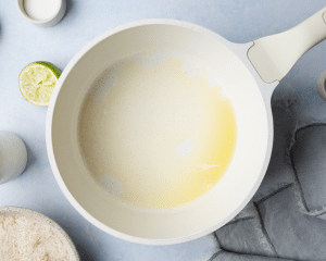 Melting butter in saucepan for coconut lime rice.