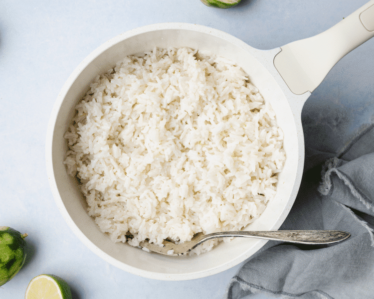 Rice cooked and fluffed in small saucepan.