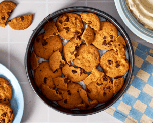 Putting cookies on the bottom of the springform pan as the first layer.