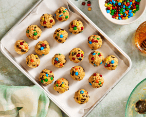 Monster energy bites scooped and rolled onto a parchment-lined baking sheet to chill for 20-30 minutes.