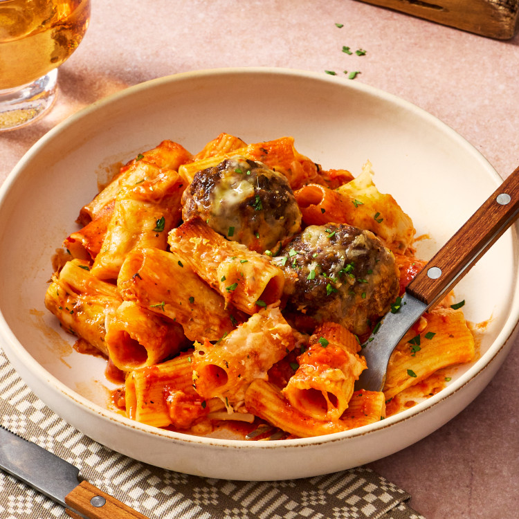 One pan meatball pasta bake served in a bowl with fork.