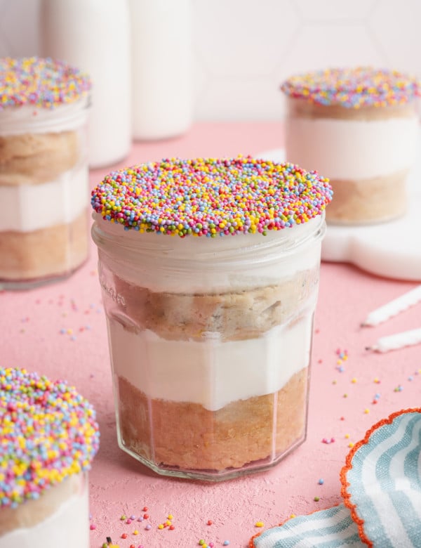 Protein dot cake in a jar decorated with sprinkles.