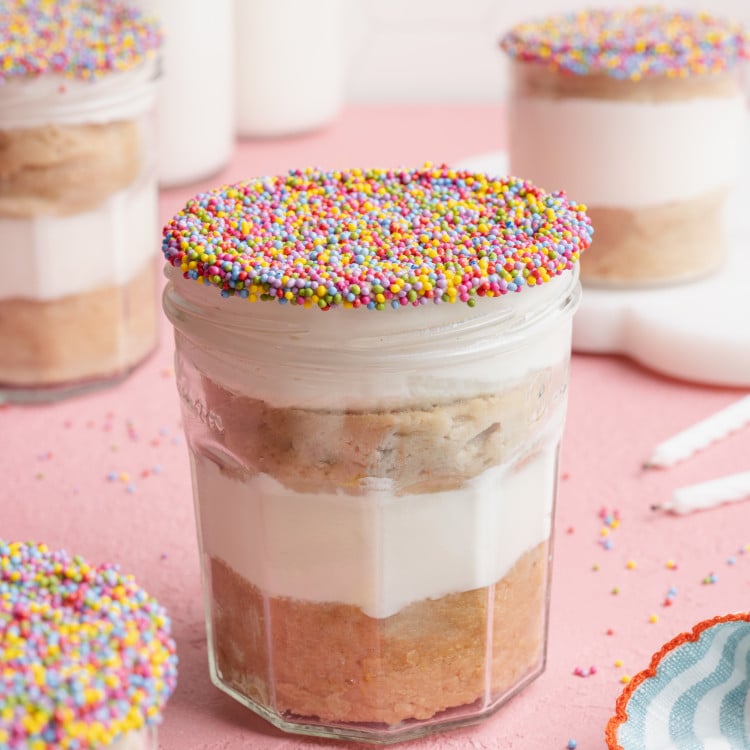 Protein dot cake in a jar decorated with sprinkles.