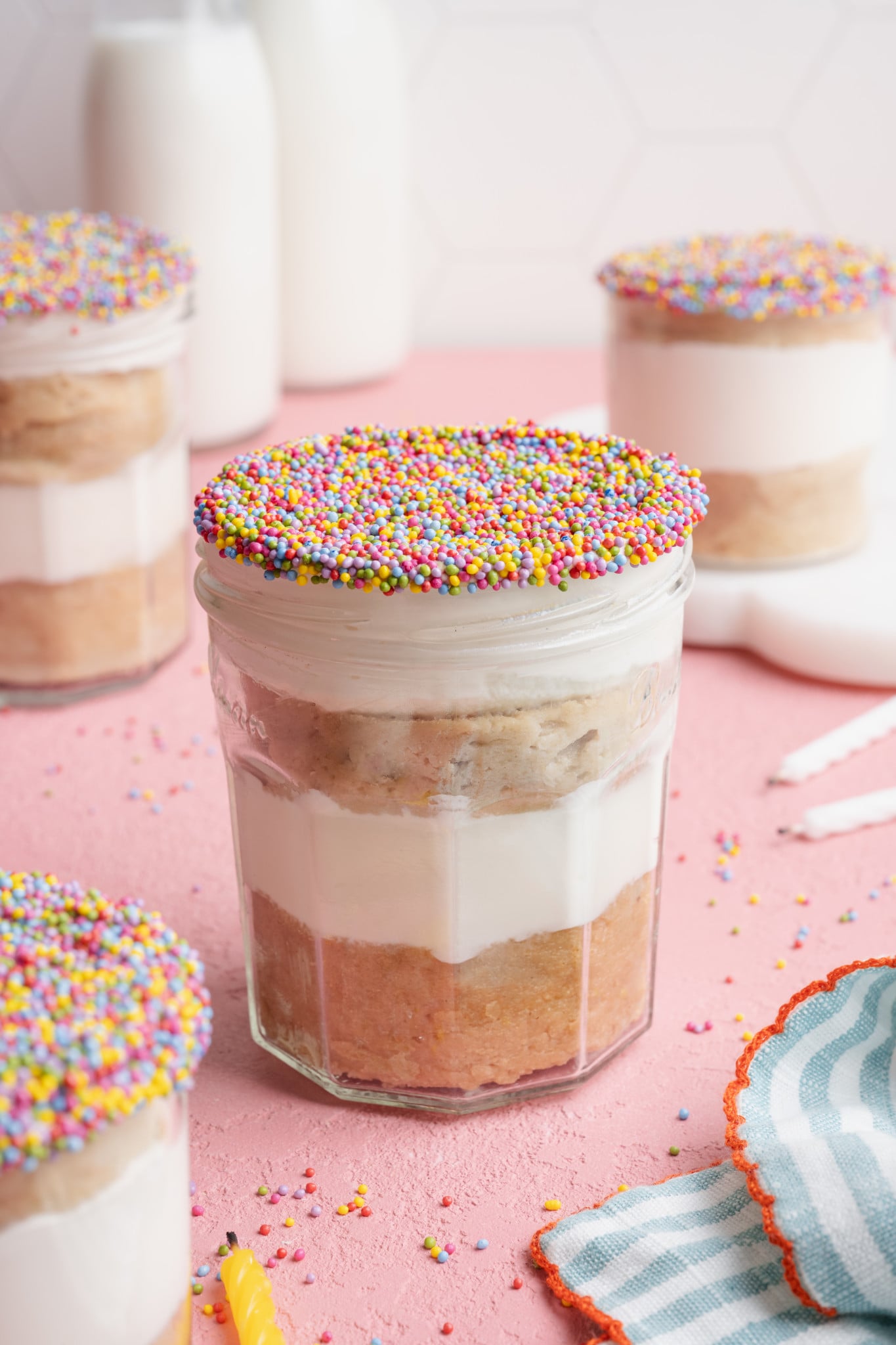 Protein dot cake in a jar decorated with sprinkles.