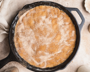 Cinnamon sugar topping sprinkled on top of snickerdoodle cookie dough.