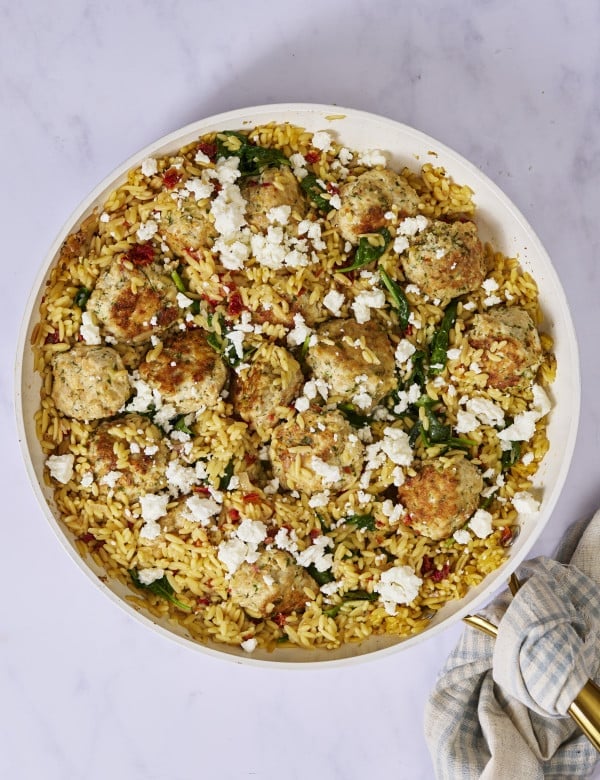 Mediterranean meatball and orzo cooked in a large skillet.