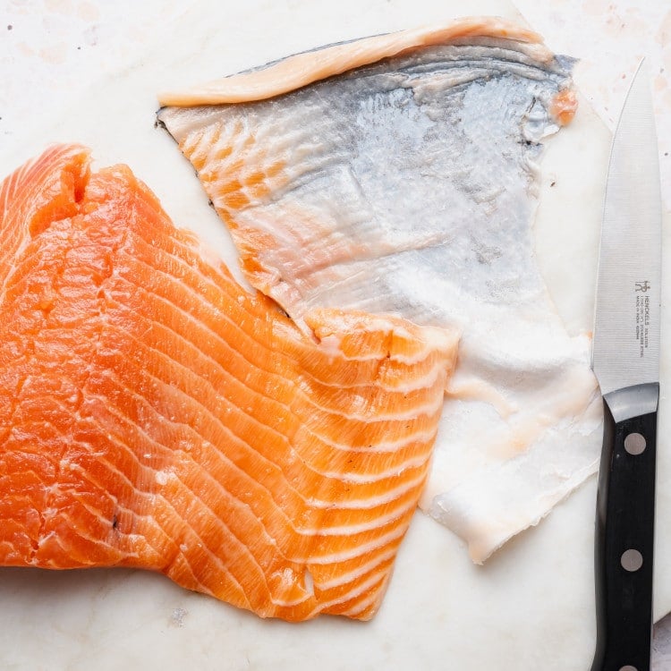 Salmon with skin removed using knife method.