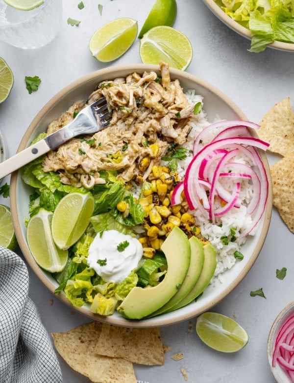 Salsa verde chicken served with toppings over rice.