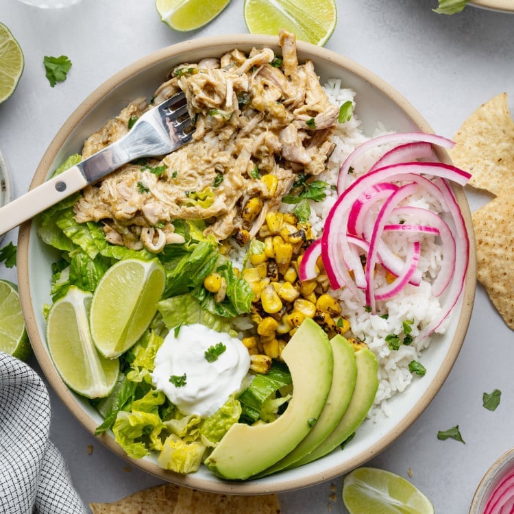 Salsa verde chicken served with toppings over rice.