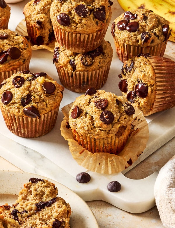 Several baked almond flour chocolate chip muffisn on cutting board.