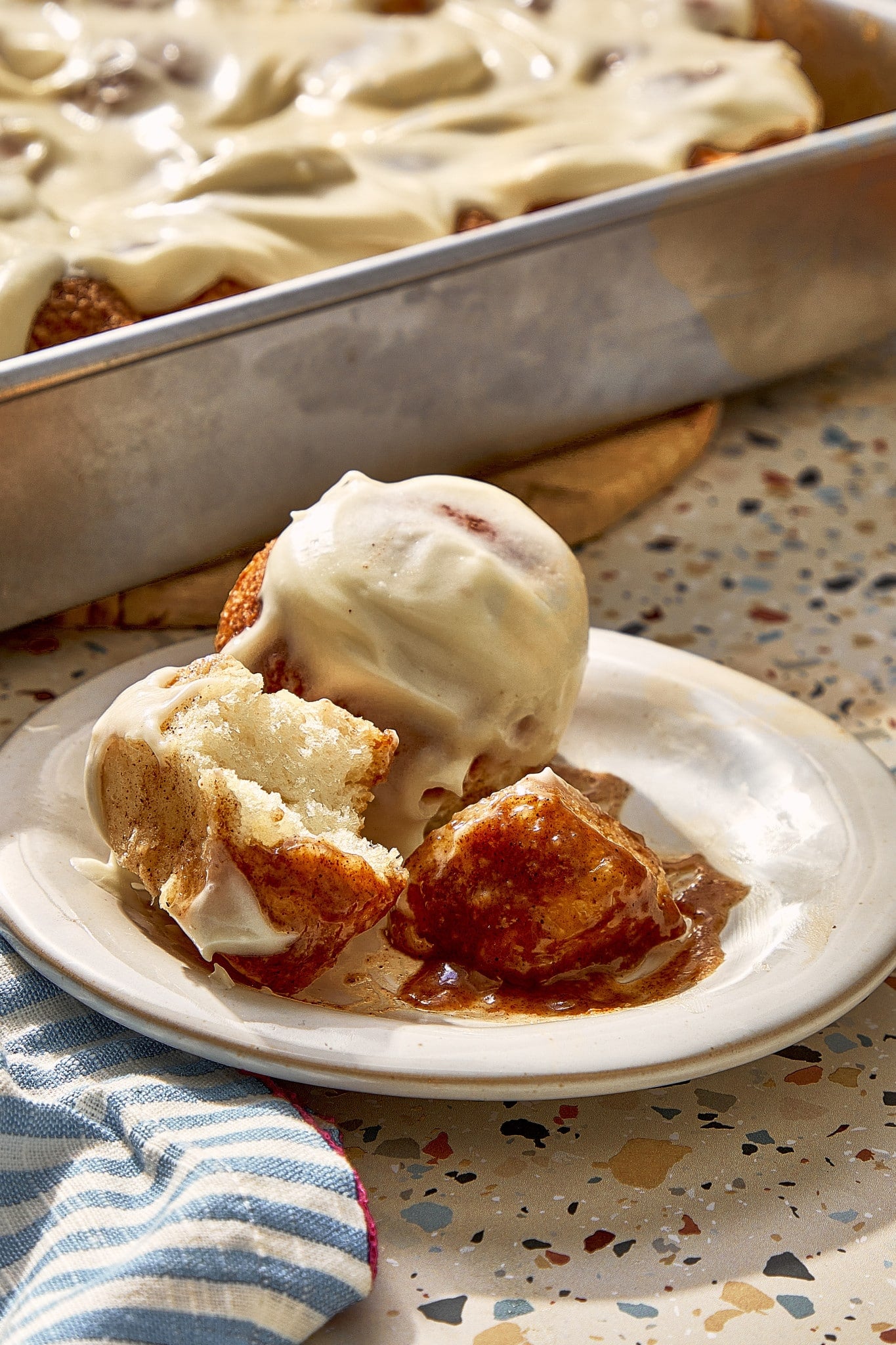 Soft, fluffy cinnamon roll bites served warm with cream cheese frosting and gooey cinnamon brown sugar sauce.