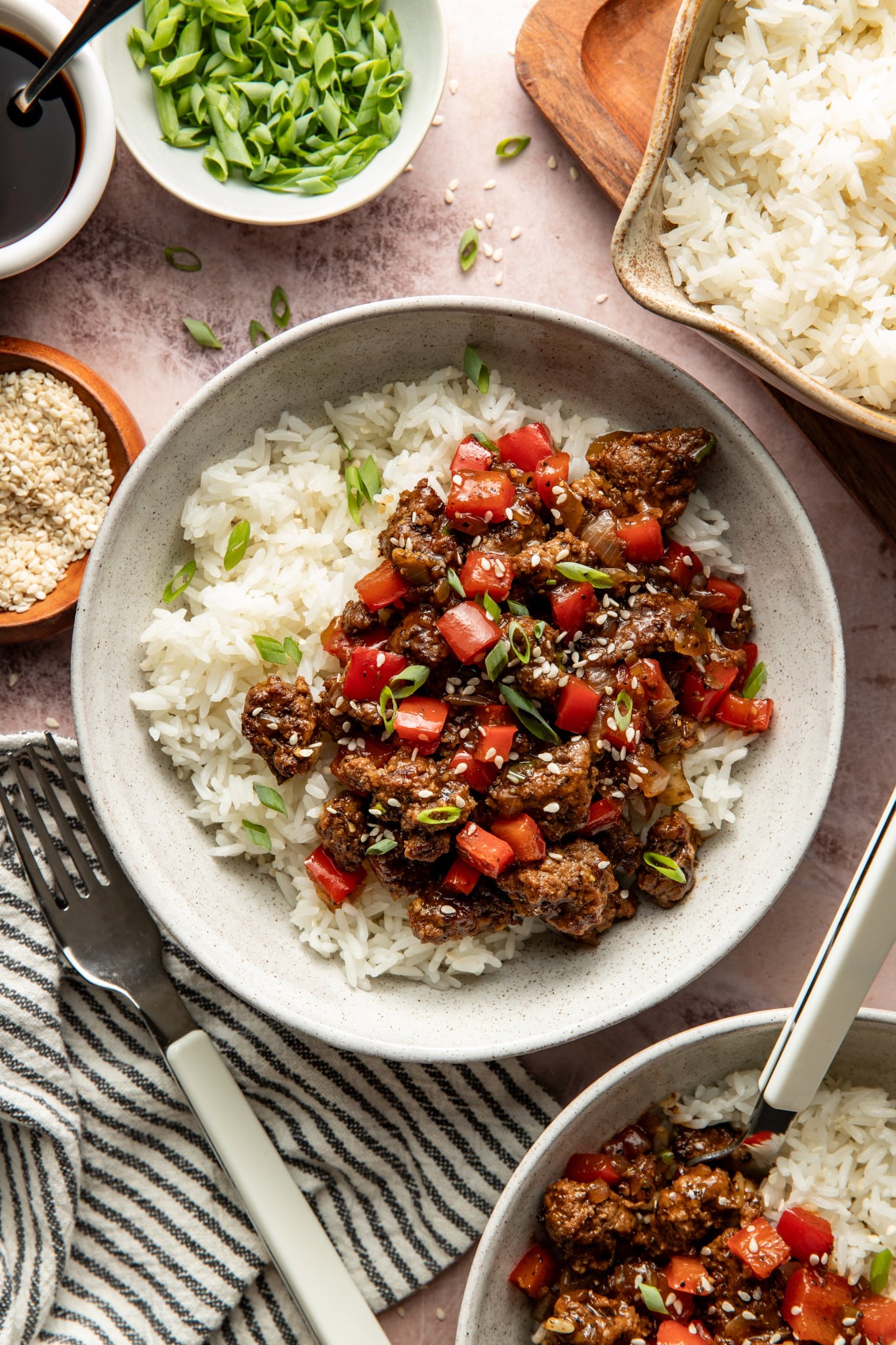 Honey garlic beef served over warm rice in a bowl.