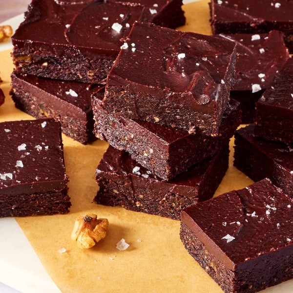 Date brownies stacked on top of each other on a plate.