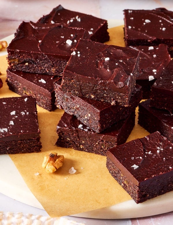 Date brownies stacked on top of each other on a plate.