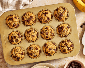 Twelve almond flour chocolate chip muffins baked in muffin tin.