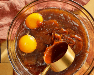 Adding the wet ingredients to the butter and sugars.