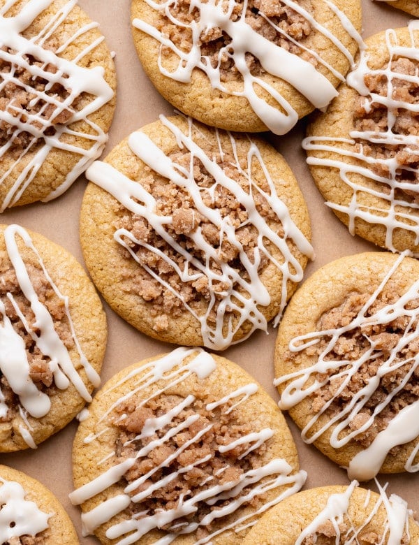 Baked pumpkin coffee cake cookies drizzled with maple glaze after cooling.