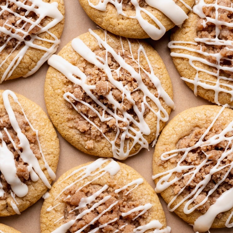 Baked pumpkin coffee cake cookies drizzled with maple glaze after cooling.