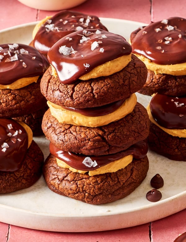 Three buckeye cookies stacked together on a plate.