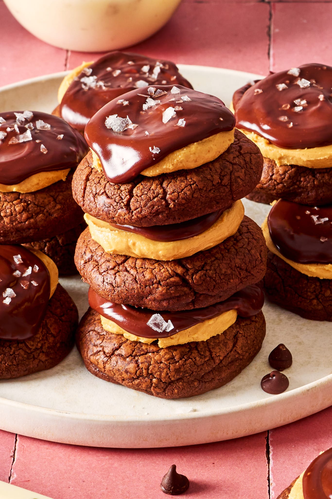 Three buckeye cookies stacked together on a plate.