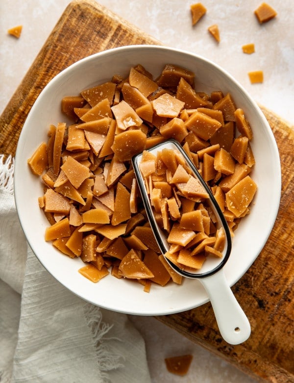 Scoop digging into bowl of homemade toffee bits.