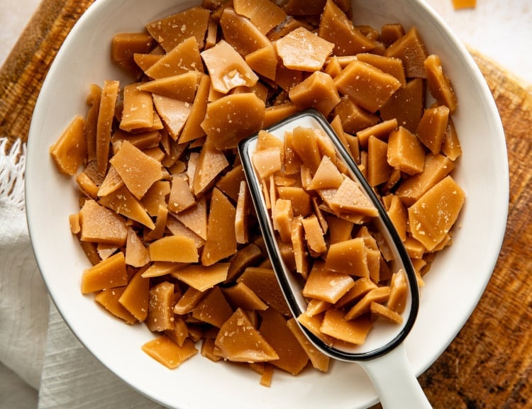Scoop digging into bowl of homemade toffee bits.