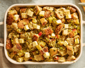Transferring stuffing mixture to a prepared 9x13 baking dish.