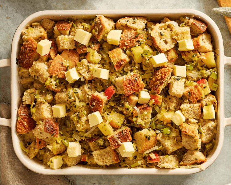 Transferring stuffing mixture to a prepared 9x13 baking dish.