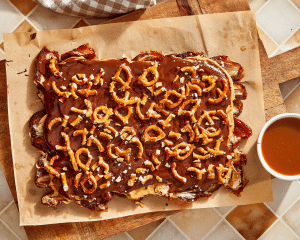 Adding pretzels on top of chocolate layer for date bark.