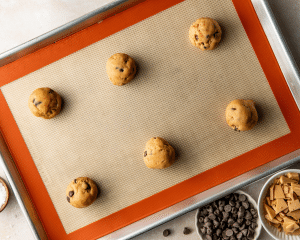 Placing six cookie dough balls on prepared baking sheet.